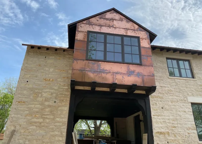 Copper metal panel facade on a stone building for Metal Roof Coating in Southern Pines